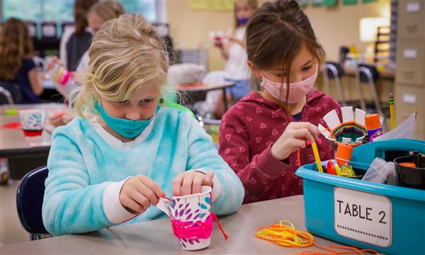 student creates woven craft